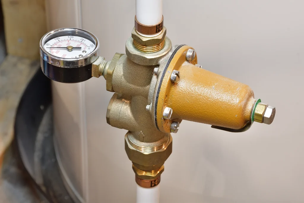 Brass pressure reducing valve with a pressure gauge installed on a water line