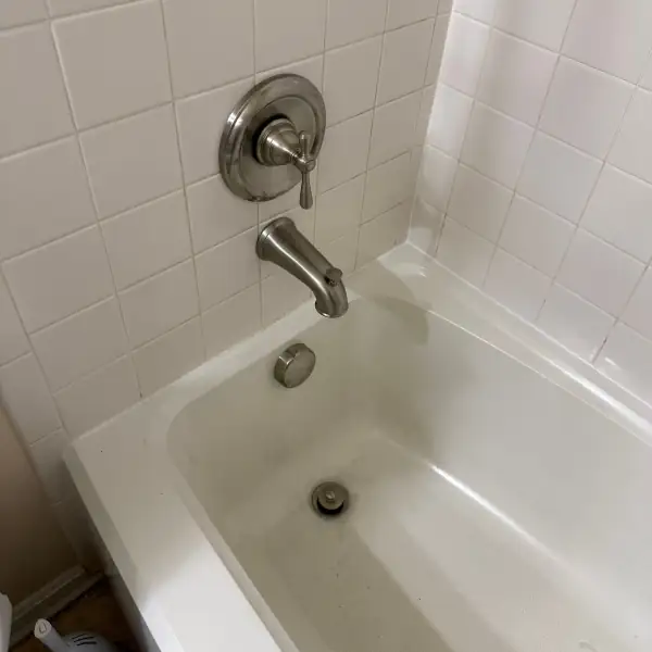 Bathtub with the repaired drain and clean finish.
