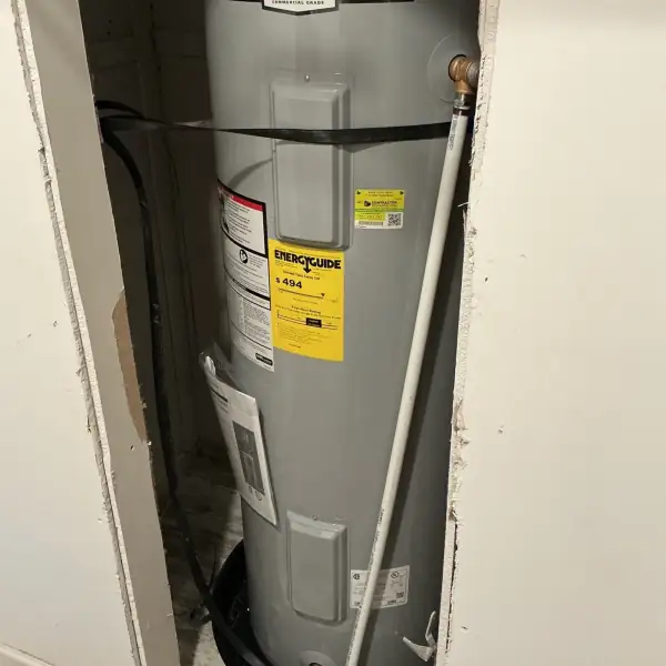 After: New tank water heater installed in the same utility closet.