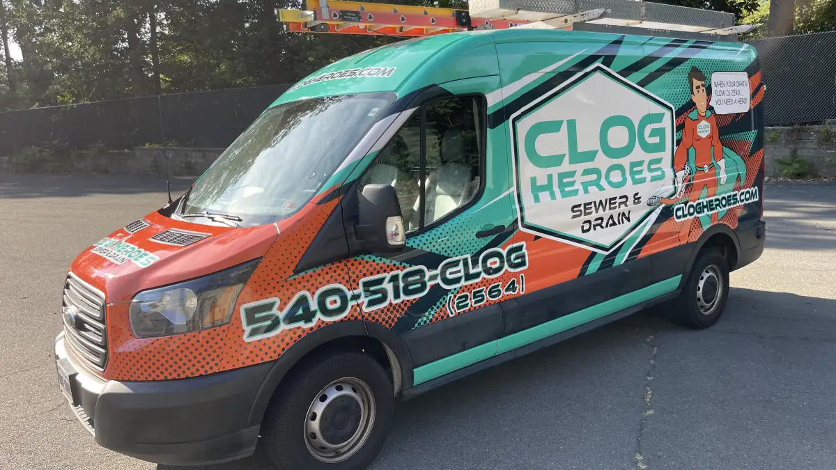 Wrapped Clog Heroes van in three-quarter front view showing the 540-518-CLOG number.