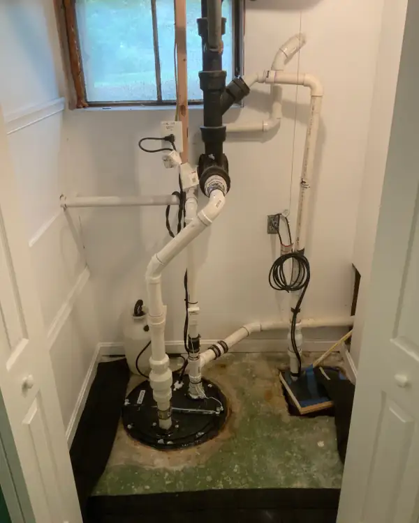 Finished sump and ejector pump installation with new PVC and check valves.