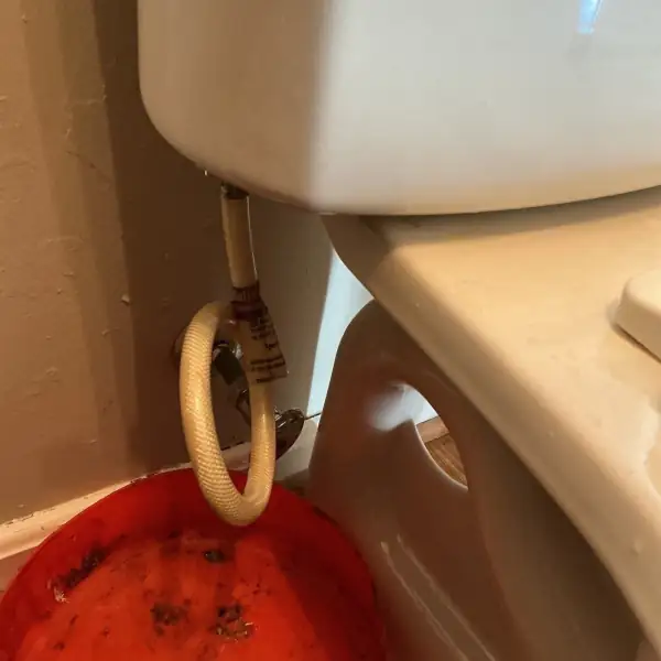 Before: Corroded toilet supply line and shut-off valve.