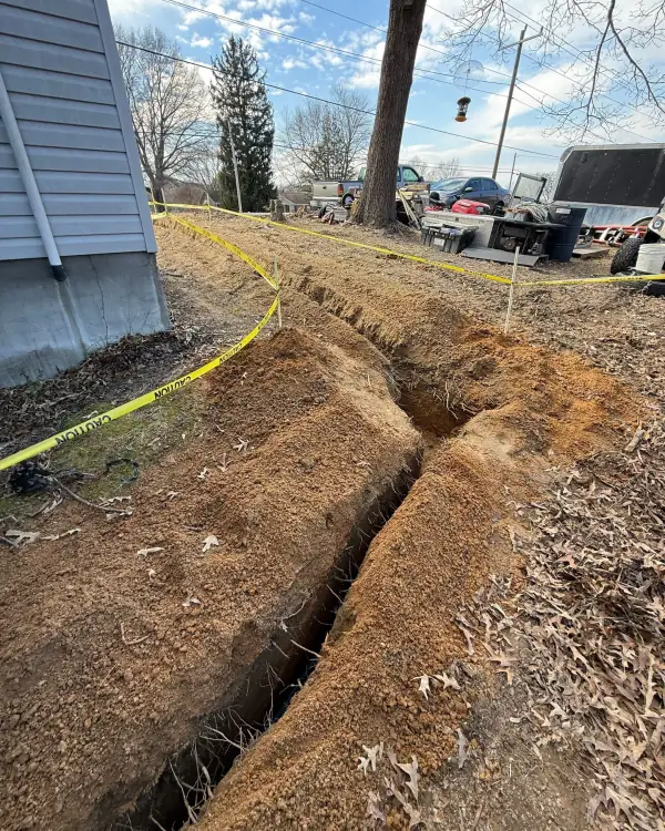 Water service trench crossing the yard.